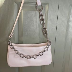 A white mini bag with front chain and a half strap half chain handle
